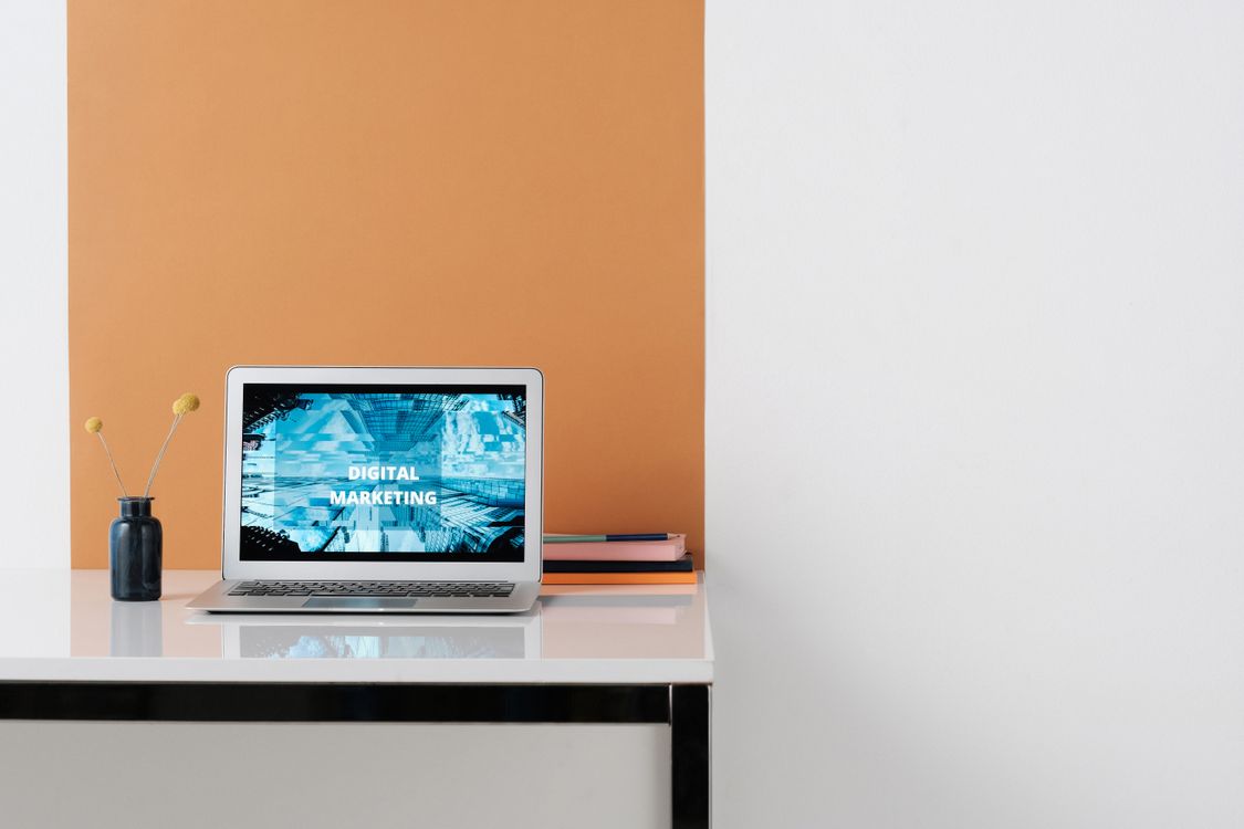 Laptop displaying digital marketing content on a desk