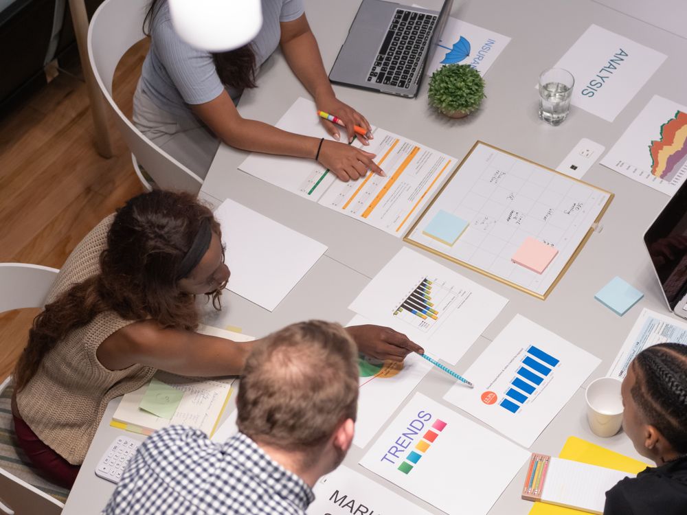 People reviewing project charts and notes around a table